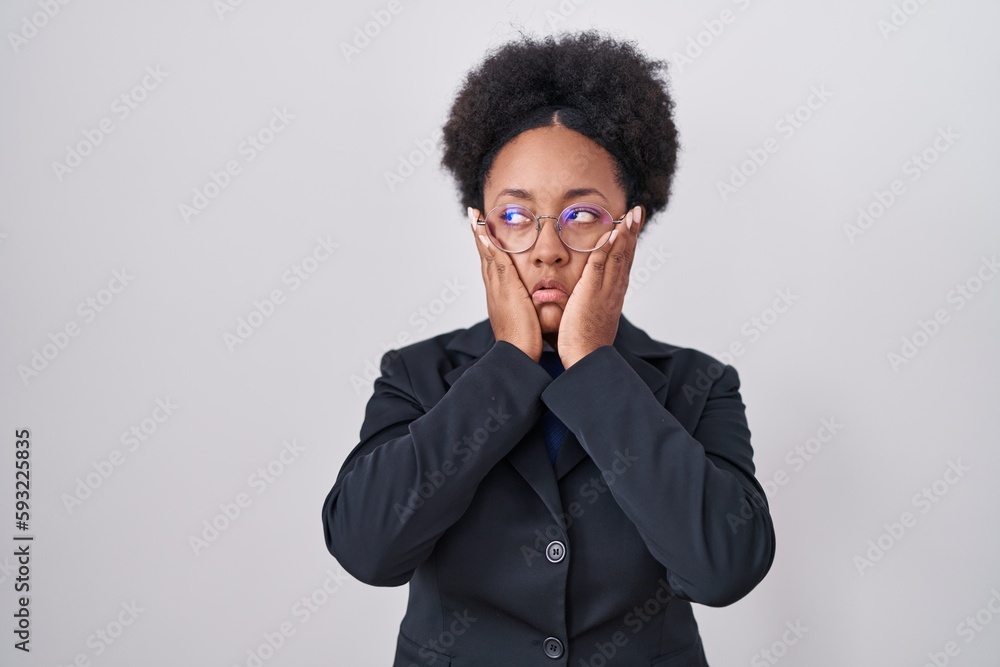 Sticker beautiful african woman with curly hair wearing business jacket and glasses tired hands covering fac