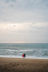 Couple in love standing beach looking at sea ocean porto portugal