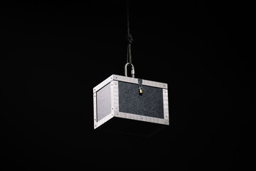 Black box hangs in a magic show, hanging from the ceiling