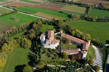 Aerial shot of the medieval Castello di Villalta in Friuli Italy with green fields in the background