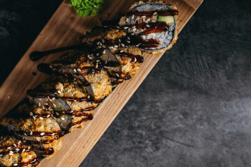 isolated sushi and rolls on a dark contrasting background, menu format

