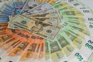 Closeup shot of Euro and USD banknotes stacked in order