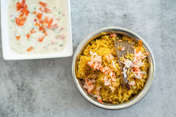 Spicy Indian biryani pulao in golden bowl with India basmati rice dish with chicken meat curry