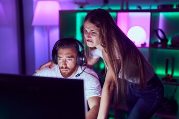 Young couple playing video games depressed and worry for distress, crying angry and afraid. sad expression.