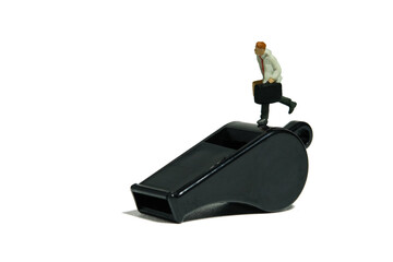 Miniature people toy figure photography. Whistle blower concept illustration. A businessman running...