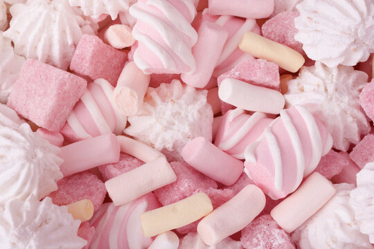 Macro of sweets with pink marshmallow, meringue cookies and strawberry sugar pieces