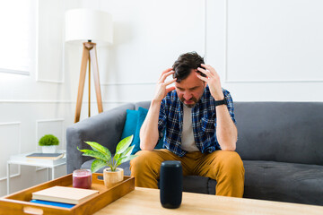 Angry young man using a broken speaker