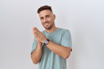 Hispanic man with beard standing over white background clapping and applauding happy and joyful, smiling proud hands together