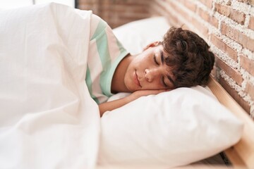 Young hispanic teenager lying on bed sleeping at bedroom