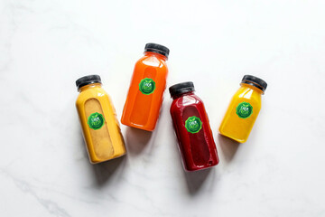 variety of juices stored in branded bottles Mango juice, Orange juice, Apple juice