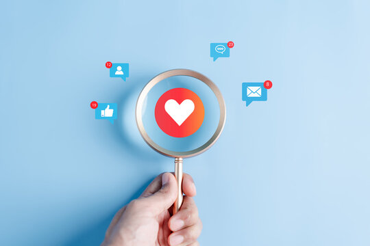 Social media and digital online, Magnifier focus to Love button emoticon, Social media. concept of living on vacation and playing social media. online marketing, technology network connection global.