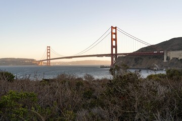 Low-angle view of Golden Gate Bridge at sunset in the USA