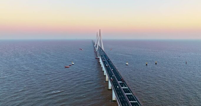 Aerial view of Hangzhou Bay Bridge scenery at sunset in Jiaxing, Zhejiang Province, China. The total length of the bridge is 36 kilometers. The design speed is 100 kilometers per hour.