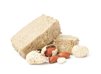 Pieces of sweet halva and peanuts on white background