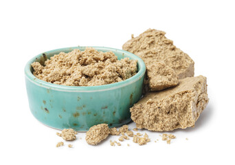 Bowl of crushed sweet halva on white background