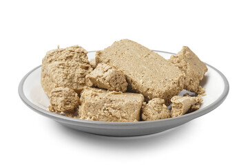 Plate with pieces of sweet halva on white background