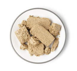 Plate with pieces of sweet halva on white background
