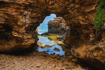 Grotto geological formation like an arch over the water in the daytime in Peterborough, Australia