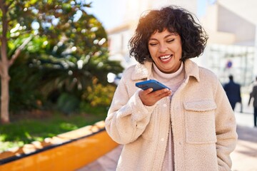Young beautiful hispanic woman smiling confident talking on the smartphone at park