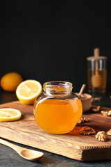 Jar of sweet honey on dark background