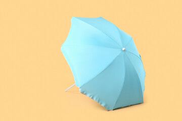 Blue beach umbrella on beige background