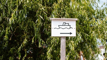 Boat parking sign with a green tree in background on the territory of Gmunden fortress in Austria