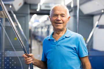Fototapeta na wymiar Portrait of mature male passenger riding in subway wagon