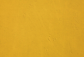 Yellow wall, texture, background. The wooden wall, painted with enamel paint. Flat surface in yellow color. Smooth and glossy surface with a yellow tint