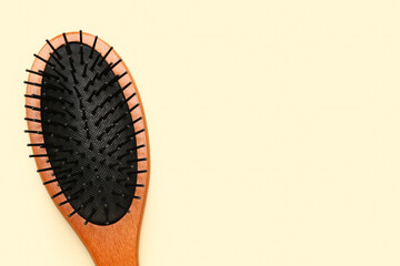 Hair brush on beige background