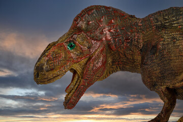 A plastic toy Tyrannosaurus Rex dinosaur on white background