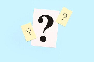 Papers with question marks on blue background