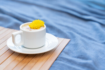 Cup of coffee with milk on a blue background with free space for text