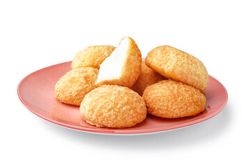 Plate with delicious choux pastry on white background