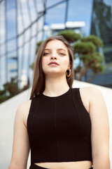 Closeup portrait of a beautiful sexy girl looking with attitude at camera, with makeup and hairstyle.