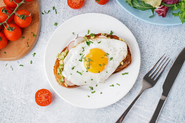 Delicious sandwich with fried egg on grunge background