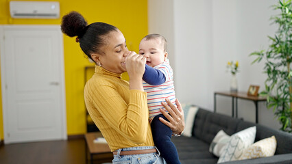 Mother and son smiling confident dancing together at home