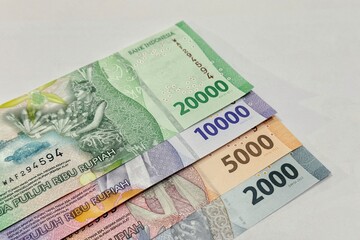 Close up of stacked Indonesian banknotes with isolated background.