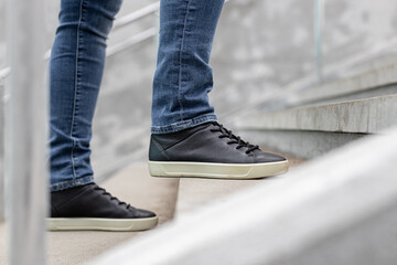 man climbs the stone steps on the street