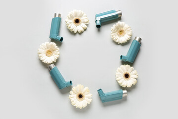 Frame made of inhaler with flowers on grey background