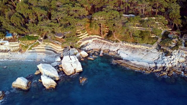 Aerial drone view of Actas beach in Faralya, Turkey. Beautiful blue water in the mediterranean sea.