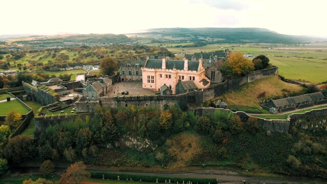 High-angle view of the Stirling castle on the top of the mountain covered by trees in Scotland.