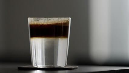 espresso tonic with straw on table
