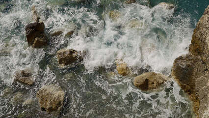 waves of mediterranean sea splashing on coastline of French Riviera