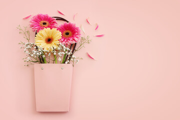 Top view image of beautiful flowers composition over pastel pink background