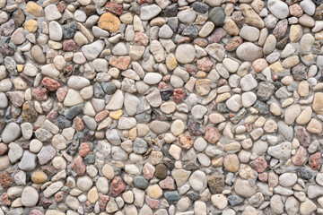 Abstract background paving consisting of small pebbles embedded in cement