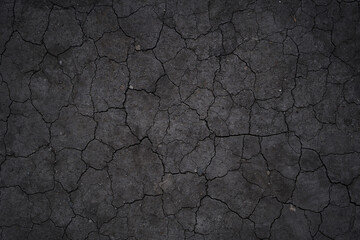 Dry cracked earth, cracks, earth in the sun, black earth, natural background with copy space. High quality photo