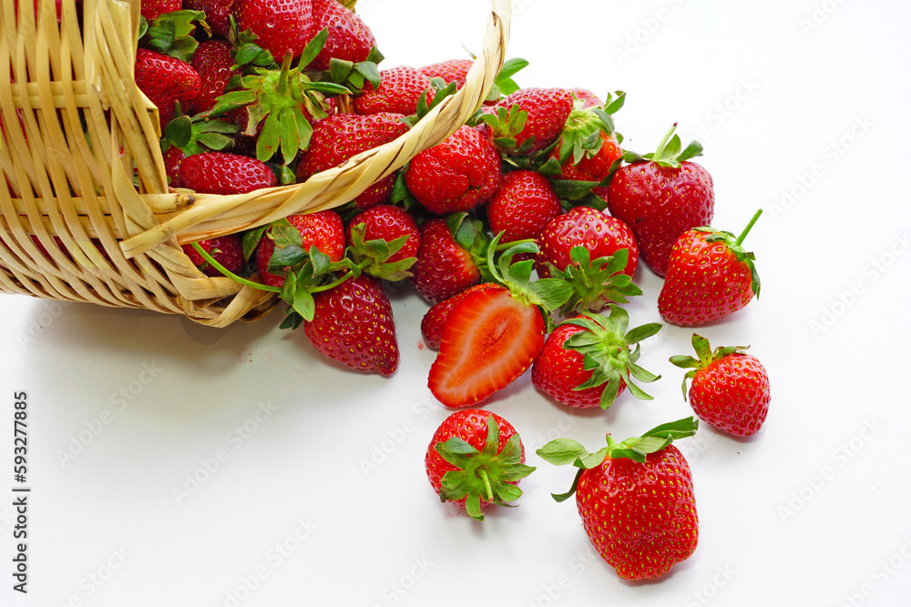 Poster fresh strawberries in a basket on white background