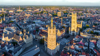 Ghent Belgium Aerial Flying over downtown area with church cityscape views at sunset time - October 2022