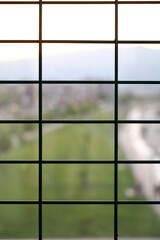 Steel fence in the city. Blurred background. Steel fence with blur view of city