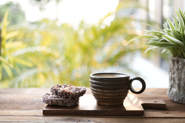 Palm cup and Rice crackers with plant on blue wooden table